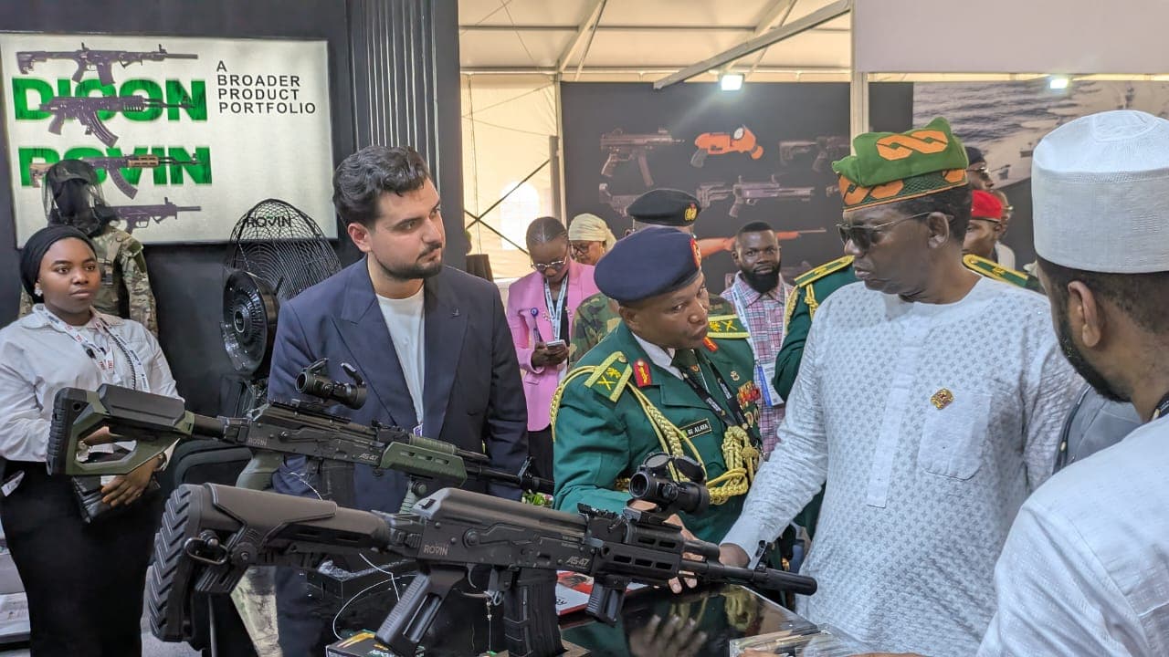 The Minister of State for Defence, Dr Bello Matawalle, and DICON's Director General looking at AS47 rifles on the DICON-Rovin Guard stand.